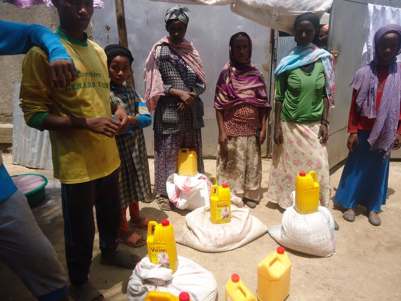 Families receiving sacks of grain and oil