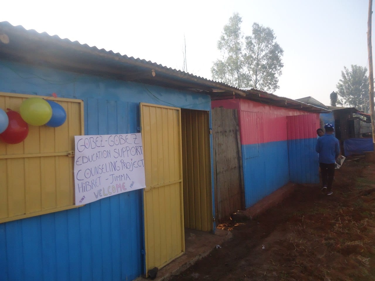 Opening day banner on a blue container shop