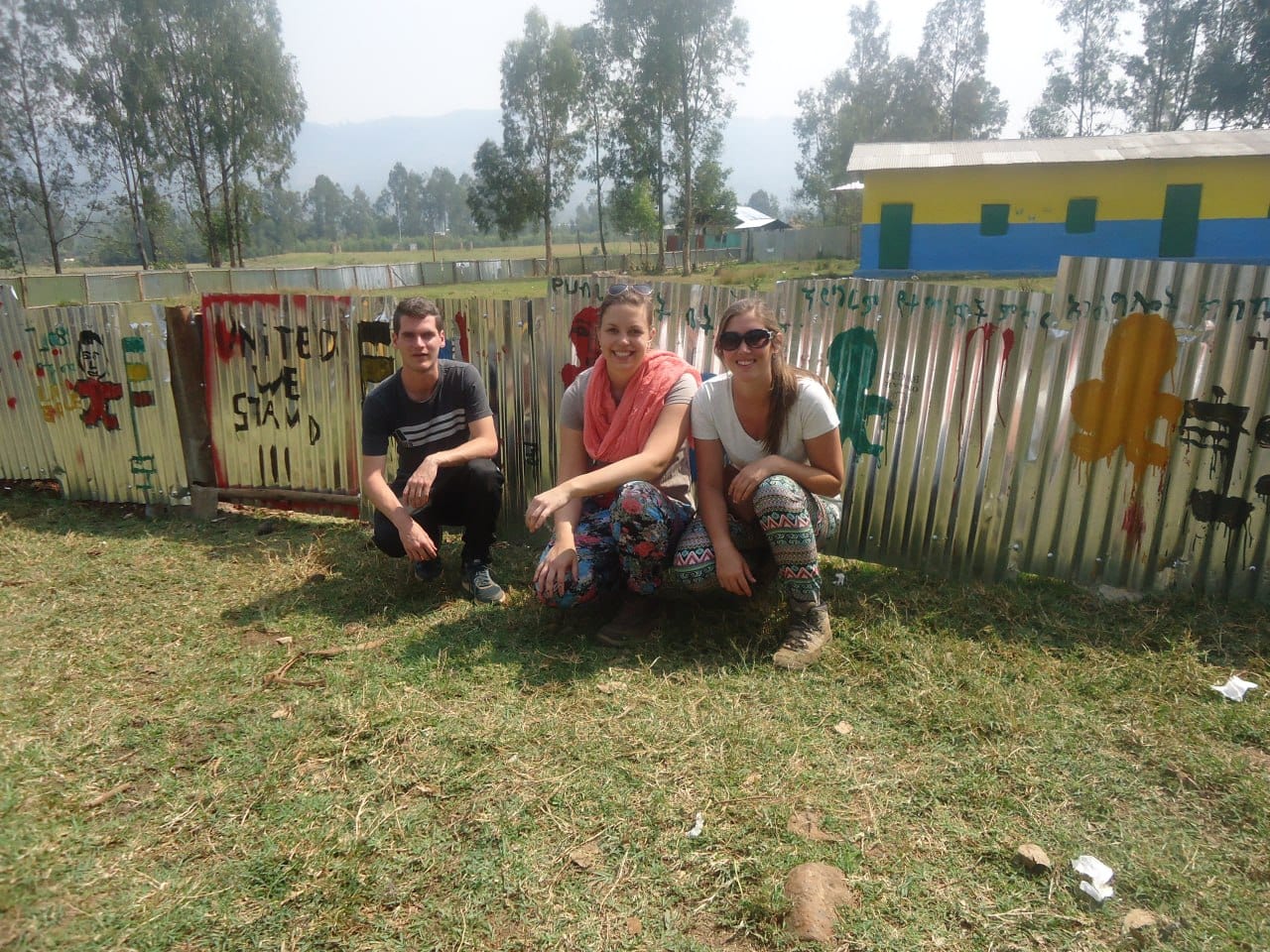 International volunteers at the fence