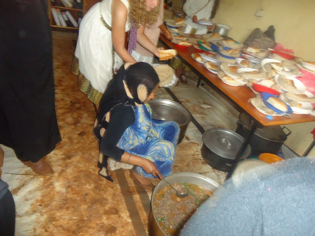 Volunteers preparing plates in a classroom